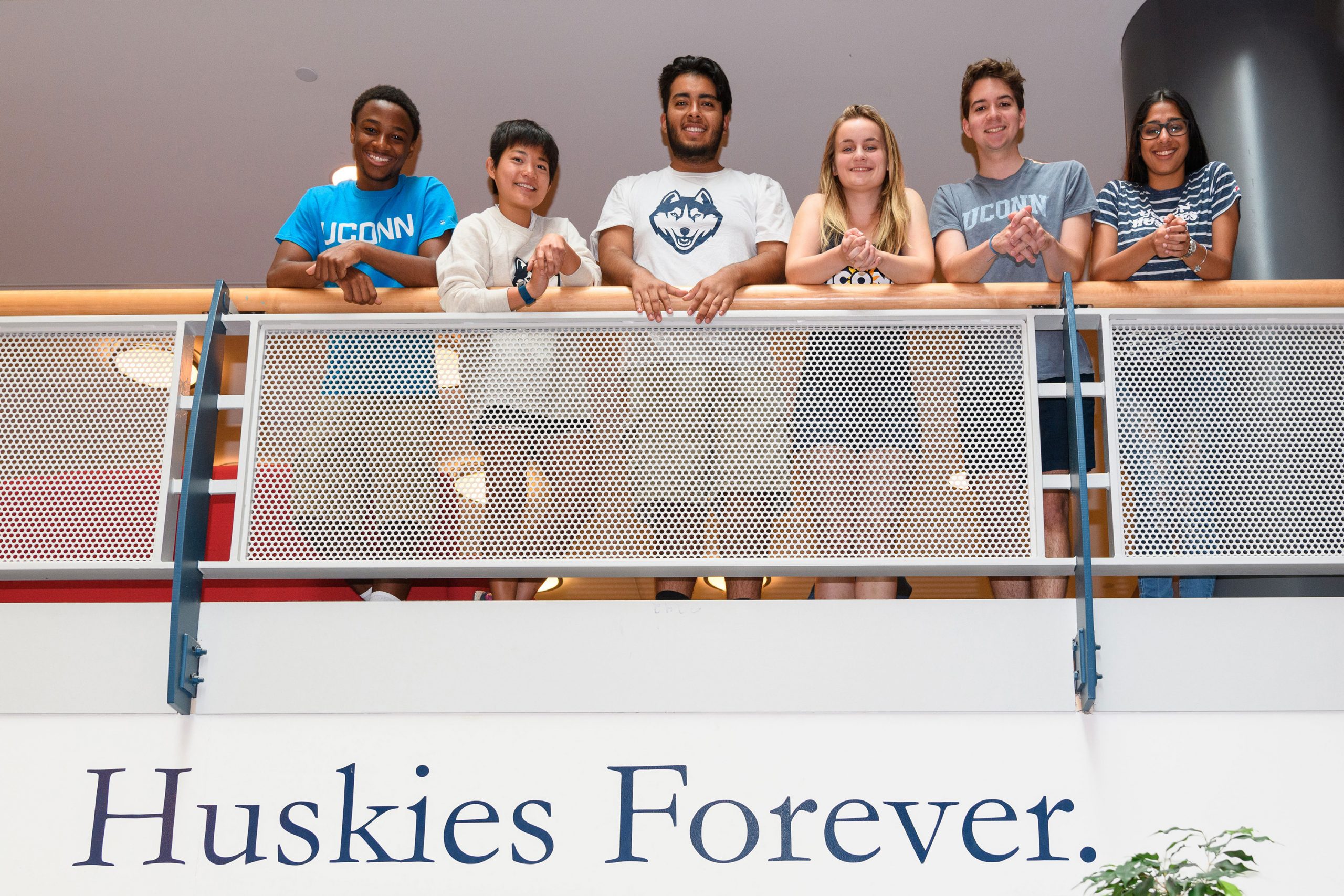 Group of UConn First Summer Students looking over a stair balcony